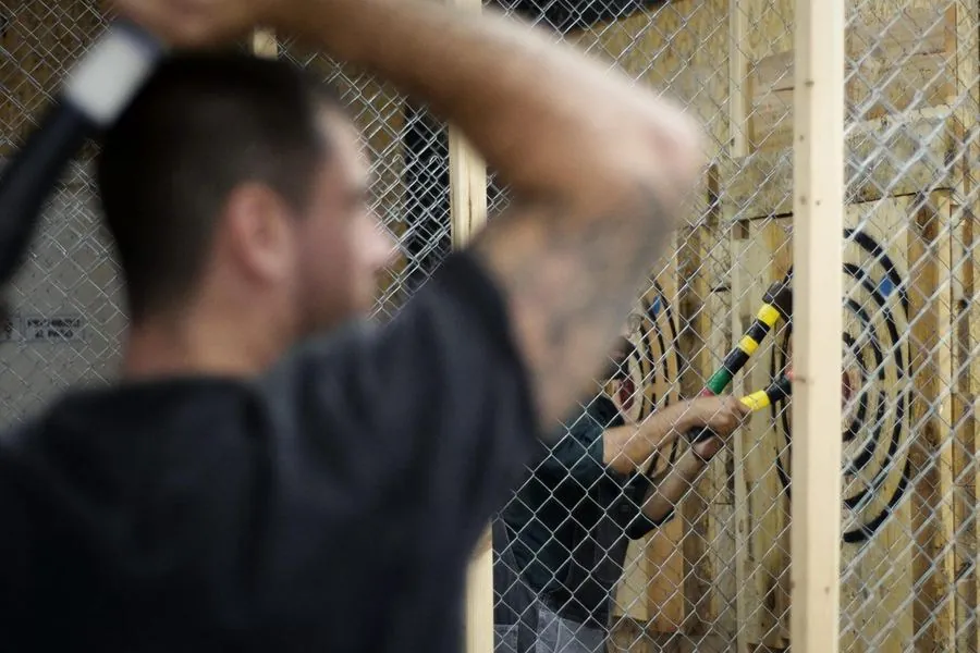 Colleagues axe throwing during a Barcelona team building event