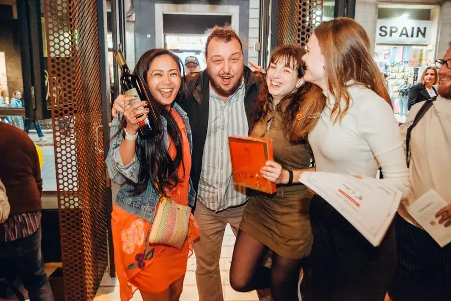 A winning team celebrating with prizes at the end of the treasure hunt