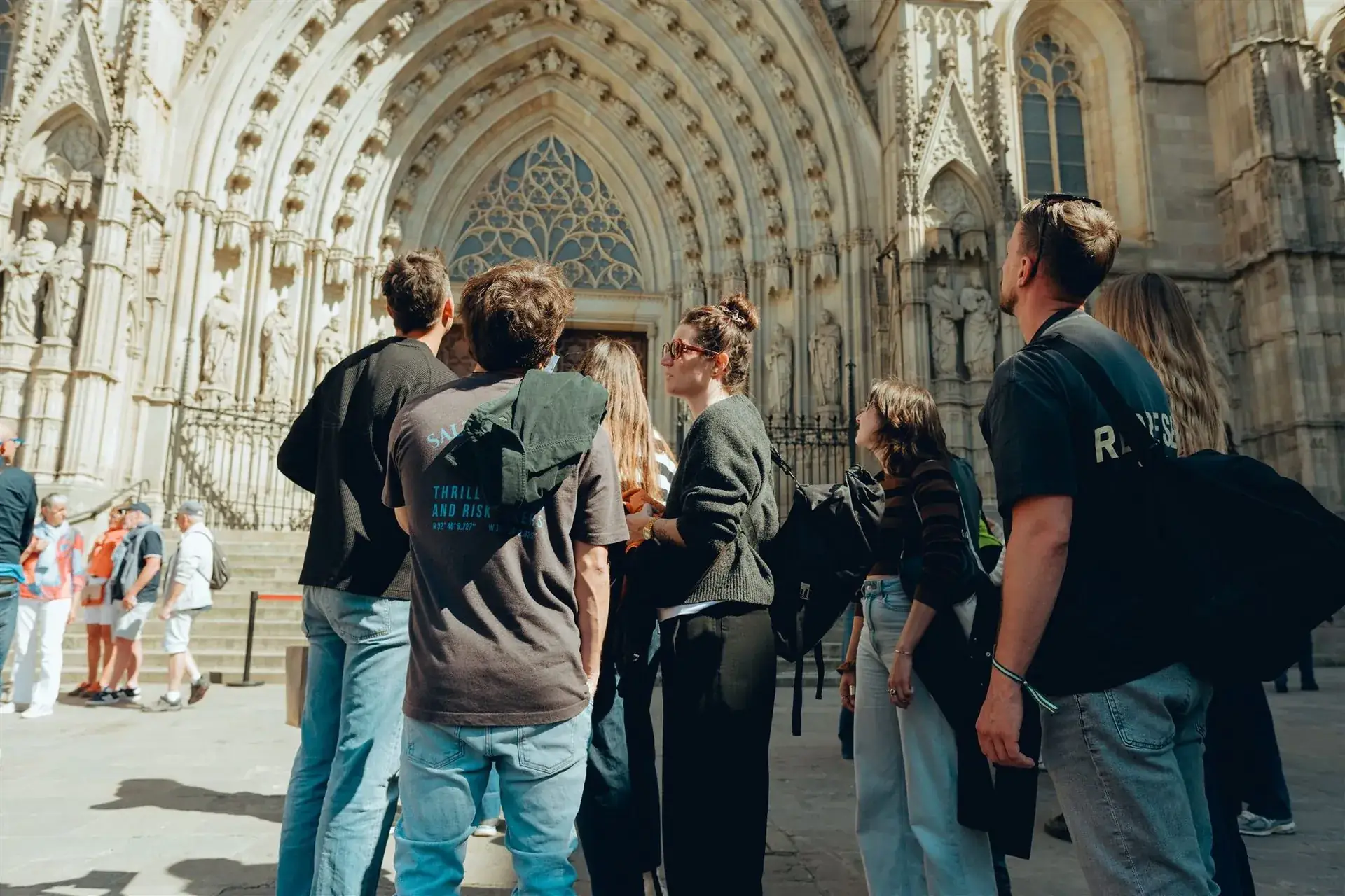 A team gathered beneath the Gothic archway of Barcelona Cathedral
