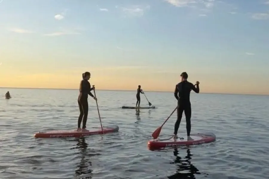 Team building stand-up paddleboarding session at Mar Bella beach, Barcelona